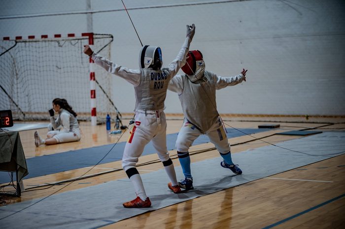 Fencers celebrating after a touch